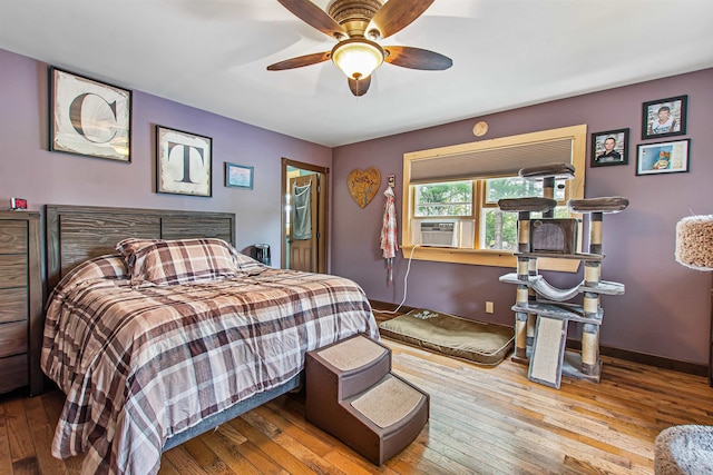 bedroom featuring ceiling fan, cooling unit, and light hardwood / wood-style floors