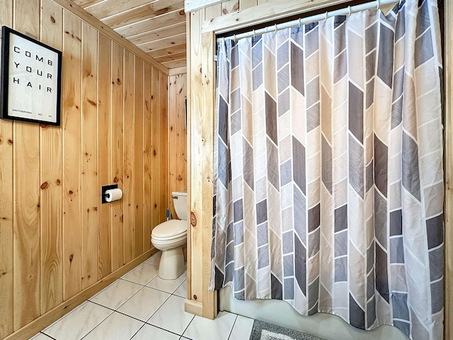 full bath with tile patterned flooring, wood ceiling, wood walls, and toilet