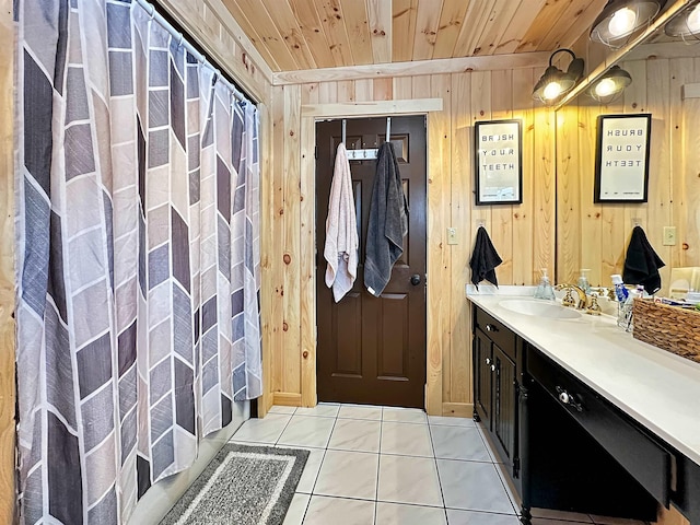 full bath with wood walls, vanity, wood ceiling, and tile patterned floors