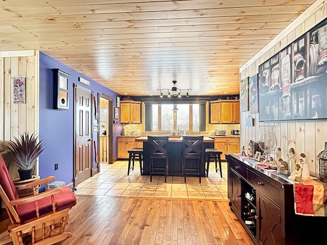 dining room with wood ceiling and light hardwood / wood-style floors