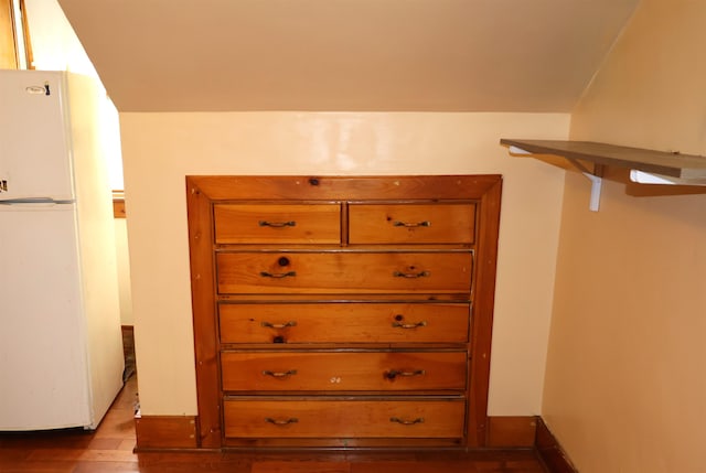 walk in closet with dark wood-type flooring