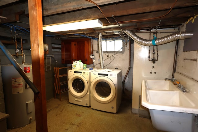 basement featuring sink, washing machine and clothes dryer, and water heater