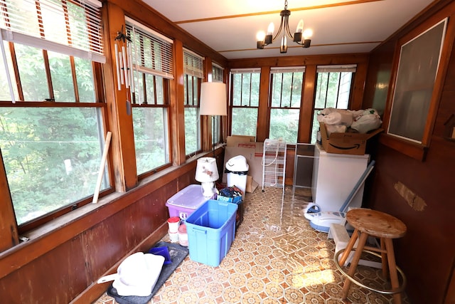 sunroom / solarium with a wealth of natural light and an inviting chandelier