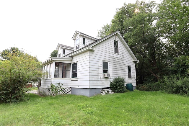 view of side of property with a lawn and cooling unit