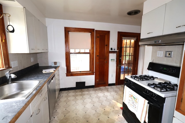 kitchen with sink, white range with gas stovetop, light tile patterned flooring, and white cabinetry