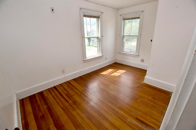 spare room with hardwood / wood-style floors