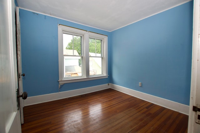 unfurnished room with dark hardwood / wood-style floors and ornamental molding