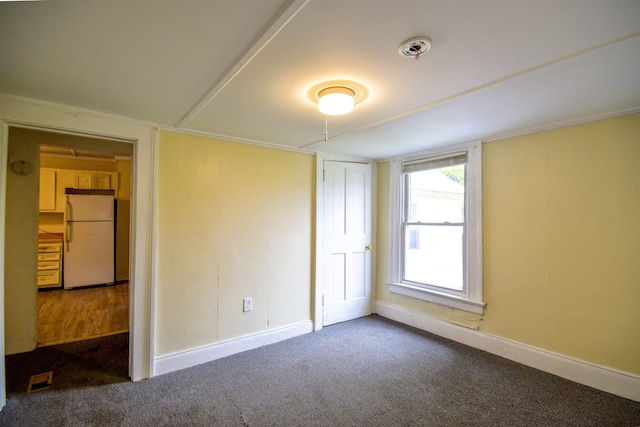 carpeted empty room featuring ornamental molding