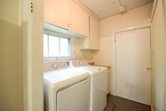 laundry room with washer and dryer and cabinets