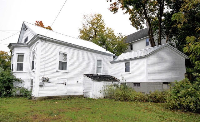 rear view of house with a yard