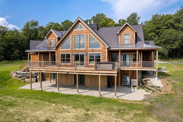 rear view of property with a yard and central AC