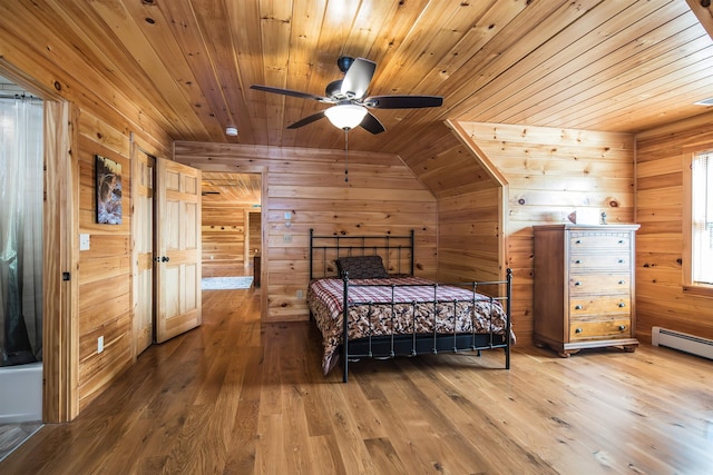 bedroom featuring wood walls, ceiling fan, wooden ceiling, hardwood / wood-style floors, and lofted ceiling
