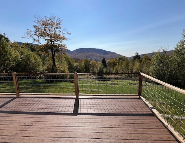wooden deck with a mountain view