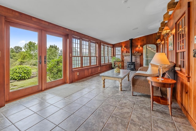 sunroom / solarium with french doors and a wood stove