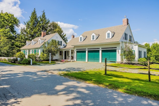 cape cod house with a chimney, a front lawn, a garage, and roof with shingles