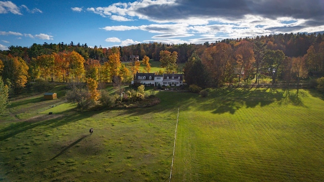 birds eye view of property featuring a rural view and a forest view