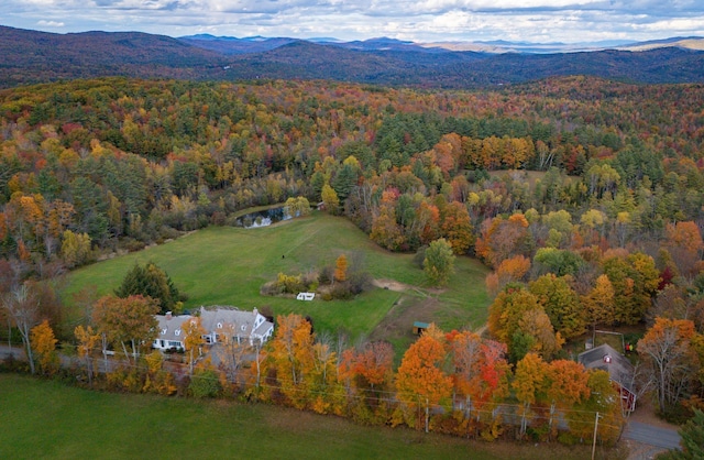 bird's eye view featuring a wooded view and a mountain view
