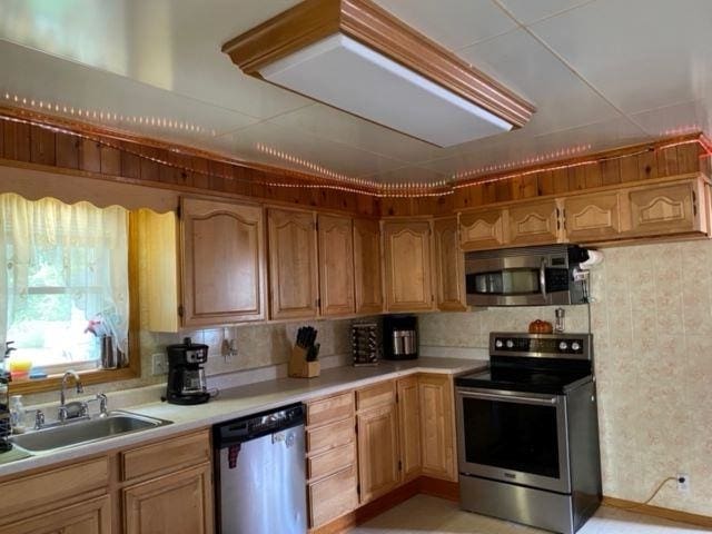 kitchen with appliances with stainless steel finishes, sink, and backsplash