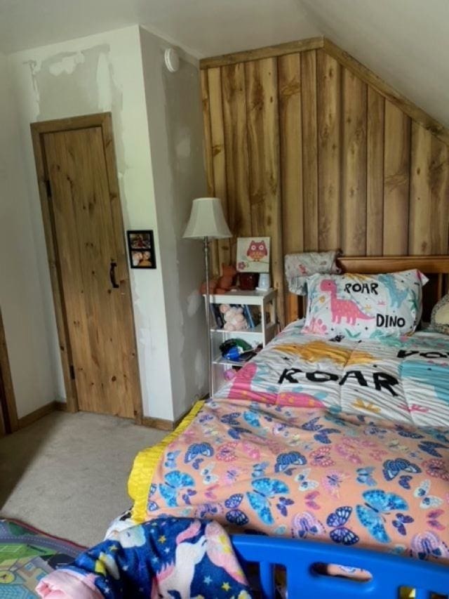 carpeted bedroom with vaulted ceiling