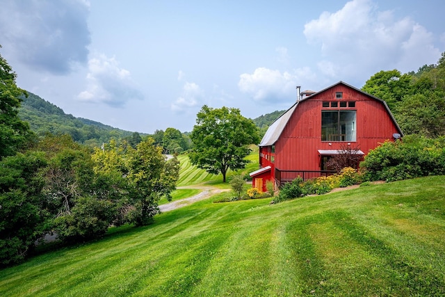 view of outbuilding with a yard and a mountain view