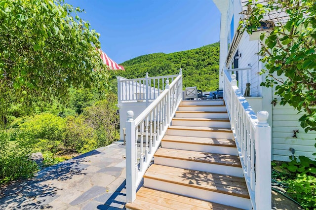 stairs featuring a view of trees