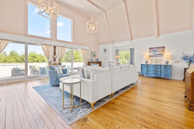 living area featuring beamed ceiling, a notable chandelier, high vaulted ceiling, and hardwood / wood-style floors