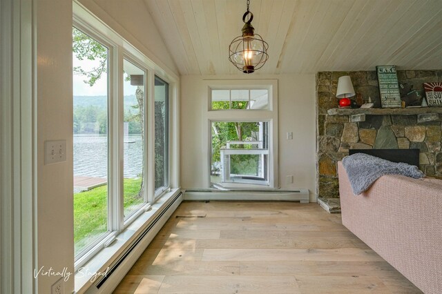 sunroom / solarium featuring plenty of natural light, a water view, and vaulted ceiling