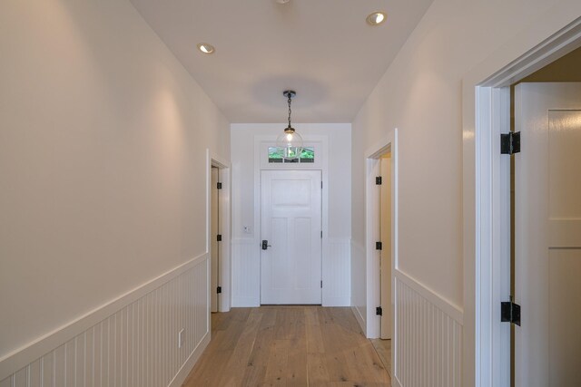 spare room featuring light wood-type flooring and lofted ceiling