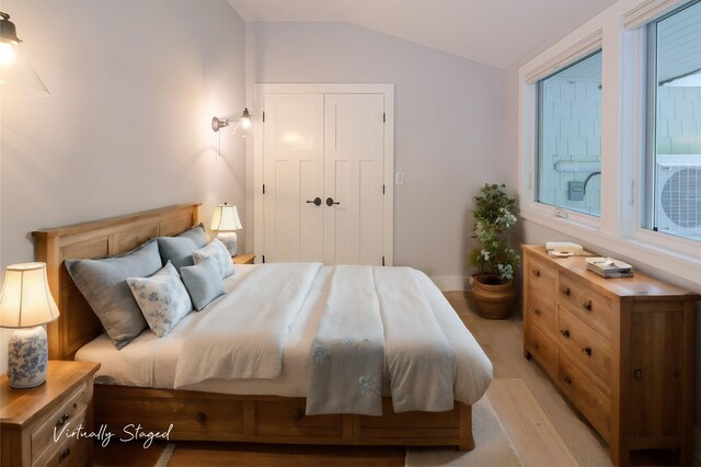 bedroom featuring hardwood / wood-style flooring and lofted ceiling