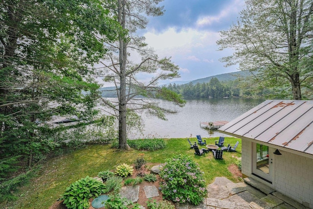 property view of water with a mountain view, a boat dock, and a fire pit