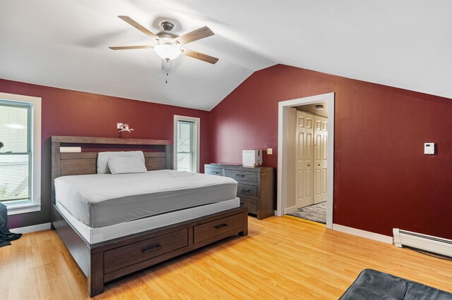 14 School St, Highgate, VT 05459 - bedroom with vaulted ceiling, baseboard heating, light wood-style flooring, baseboards, and ceiling fan