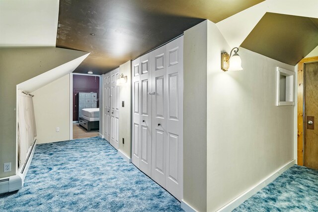 14 School St, Highgate, VT 05459 - corridor with a baseboard radiator, vaulted ceiling, baseboards, and carpet