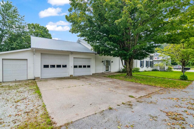 14 School St, Highgate, VT 05459 - view of front of property with a front lawn, metal roof, and a garage