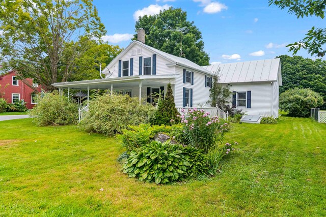 14 School St, Highgate, VT 05459 - view of front of home with a chimney and a front yard