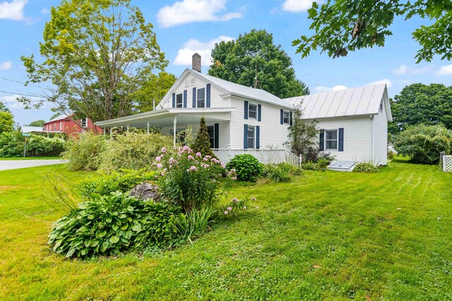 14 School St, Highgate, VT 05459 - back of house featuring a chimney, a carport, and a lawn