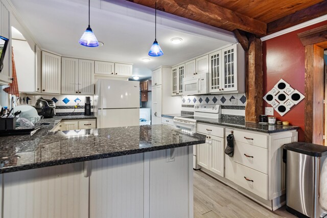 14 School St, Highgate, VT 05459 - kitchen with light wood-type flooring, white appliances, dark stone countertops, backsplash, and a peninsula