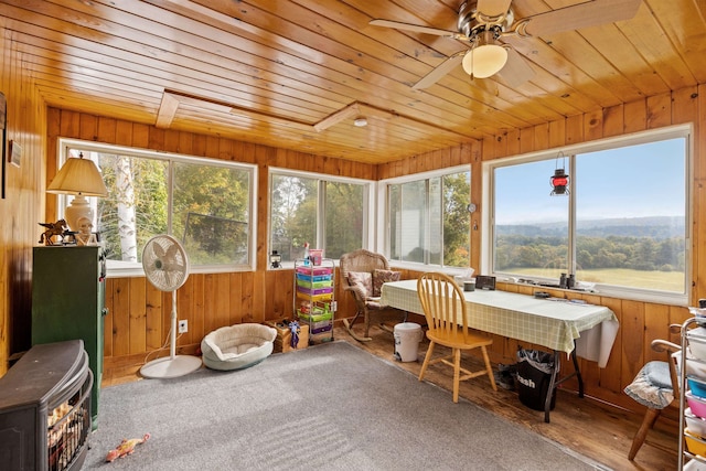 sunroom featuring ceiling fan and wooden ceiling