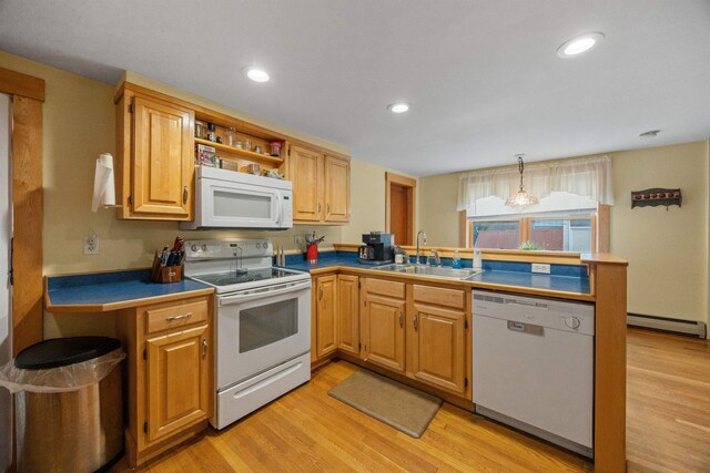 kitchen with light wood-style flooring, a peninsula, white appliances, a sink, and baseboard heating