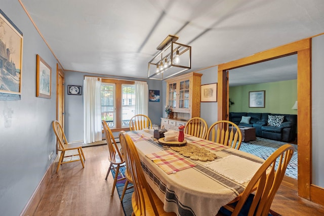 dining space featuring wood finished floors and baseboards