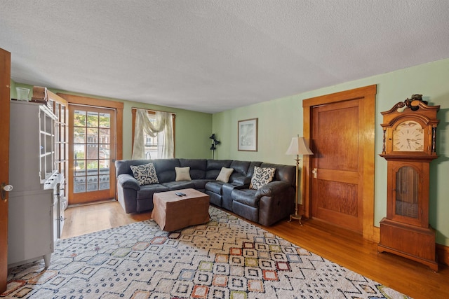 living room with a textured ceiling and wood finished floors