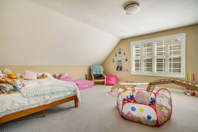 carpeted bedroom with lofted ceiling