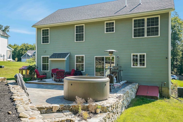 back of house featuring a yard and a patio area