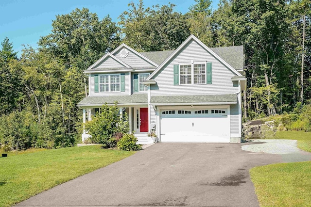 view of front facade with a garage, a porch, and a front lawn