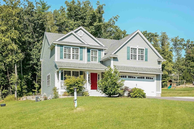 view of front of house featuring a garage, covered porch, and a front yard