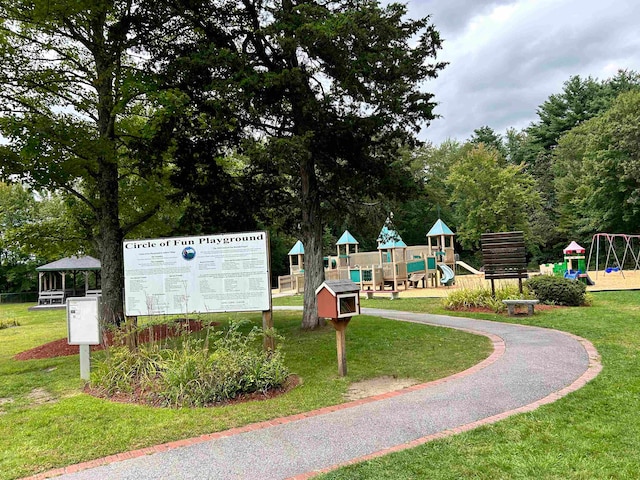 view of property's community with a playground and a lawn