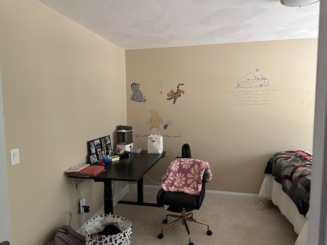 carpeted home office with a textured ceiling