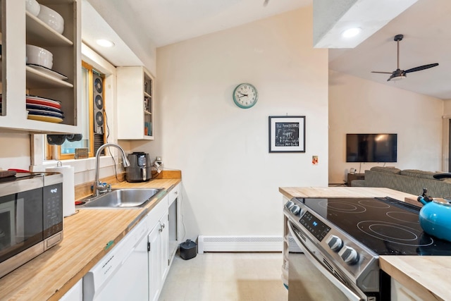 kitchen featuring ceiling fan, white cabinetry, a baseboard heating unit, lofted ceiling, and stainless steel appliances