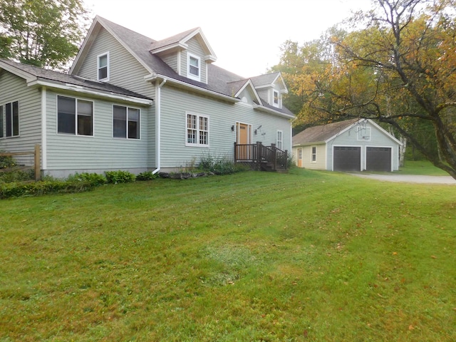 exterior space featuring a front lawn, an outdoor structure, and a garage