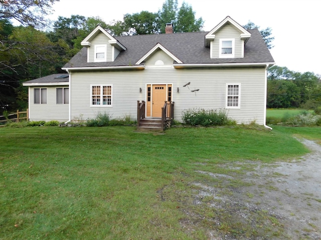 cape cod house featuring a front yard