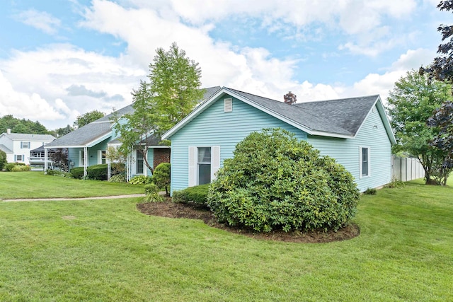 view of side of property featuring a lawn